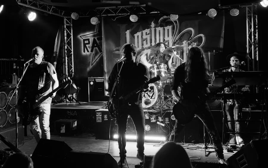 Wide live photo of Losing Gravity on stage with the full band visible
