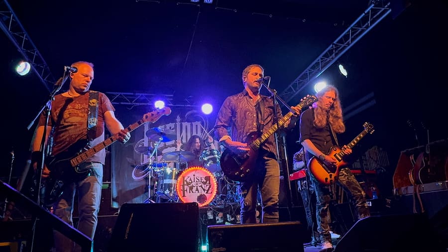 Losing Gravity performing live under blue and purple venue lights