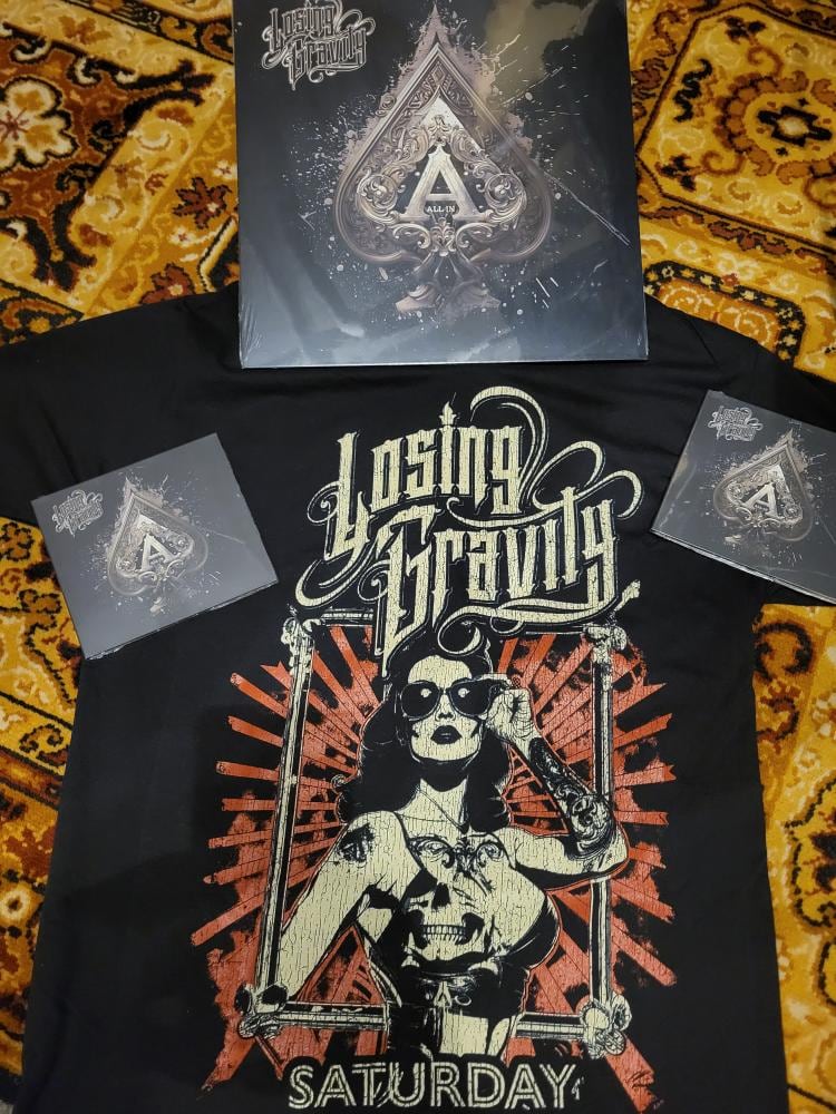 All In vinyl and CDs displayed with a Saturday Night shirt